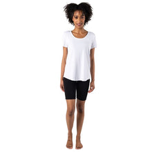 female model wearing white brenda u-neck tee and terrera black essential shorts front view on white bacground