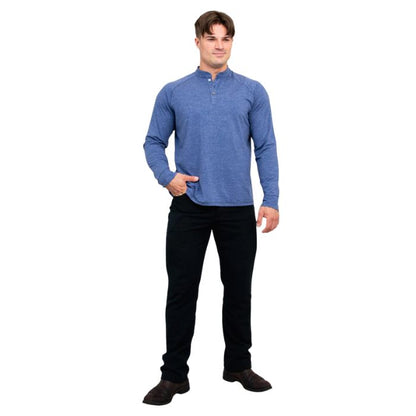 male model wearing denim blue brody long sleeve shenley shirt and black pants front view on white background