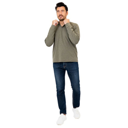 male model wearing khaki green brody long sleeve shenley shirt and blue jeans front view on white background