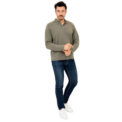 male model wearing khaki green brody long sleeve shenley shirt and blue jeans front view on white background