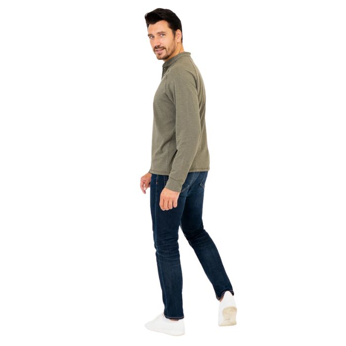 male model wearing khaki green brody long sleeve shenley shirt and blue jeans side view on white background