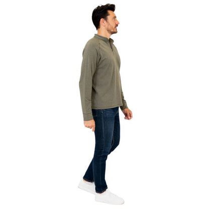 male model wearing khaki green brody long sleeve shenley shirt and blue jeans side view on white background