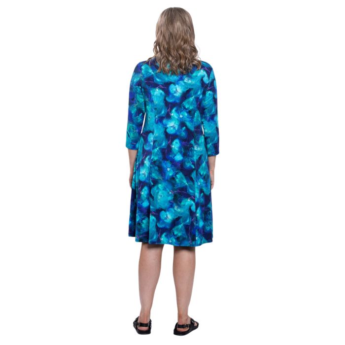 female model wearing ocaen reef print callie dress back view on white background