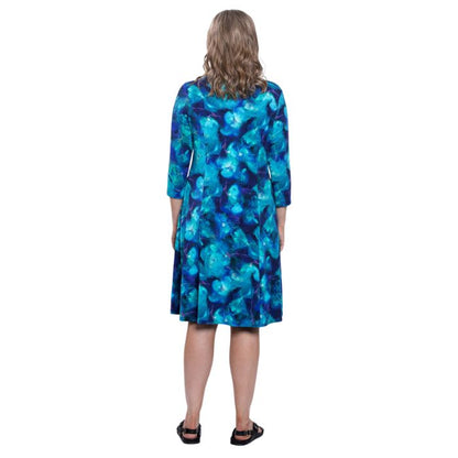 female model wearing ocaen reef print callie dress back view on white background