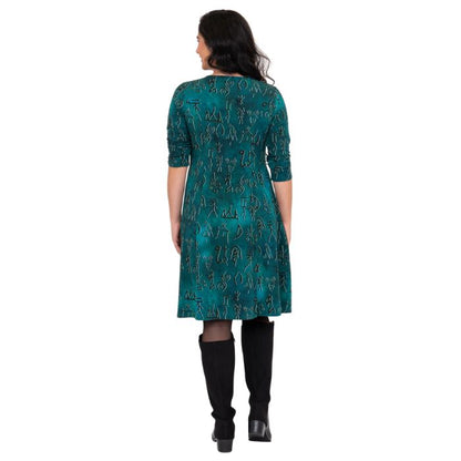 female model wearing teal rune print callie dress back view on white background