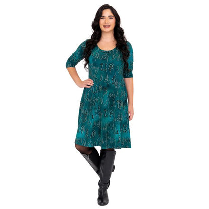 female model wearing teal rune print callie dress front view on white background