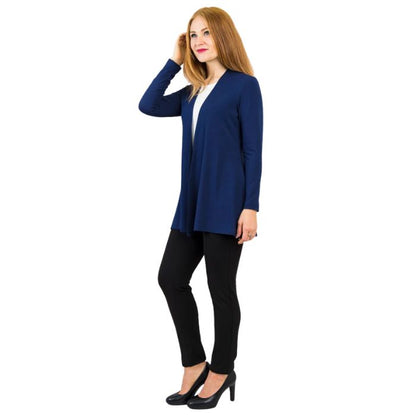 female model wearing indigo blue chopra jacket, white reanna tank top and black nadia pants side view on white background