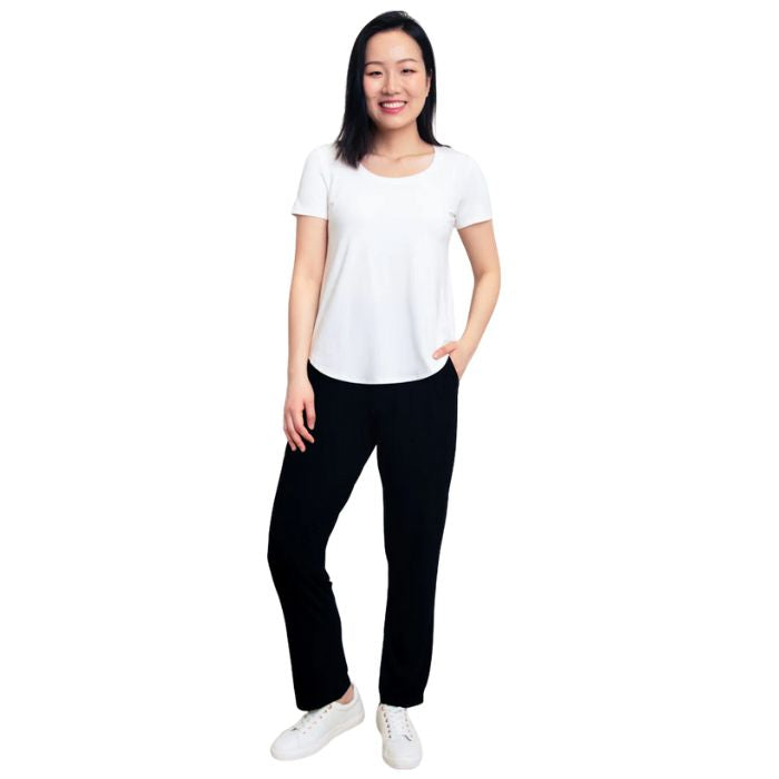 bottom of female model wearing black clair pants and white tessa tee front view on white background