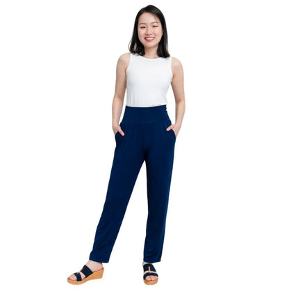 female model wearing indigo blue clair pants and white reanna tank top front view on white background