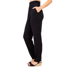 bottm of female model wearing black clair pants tall side view on white backround