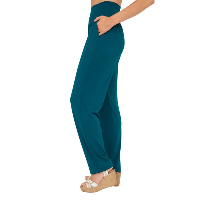 female model wearing teal green clair pants waist down side view on white background