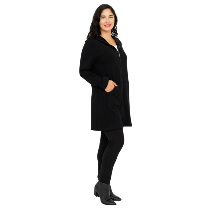 a woman wearing black cortes jacket and black dixie fleece leggings side view set on a studio white background
