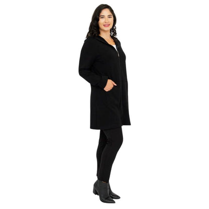 a woman wearing black cortes jacket and black dixie fleece leggings side view set on a studio white background