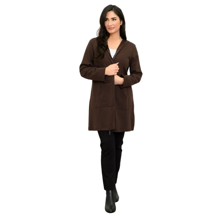 a woman wearing coffee brown cortes jacket, white jazz tank top and black nadia pants front view set on a studio white background