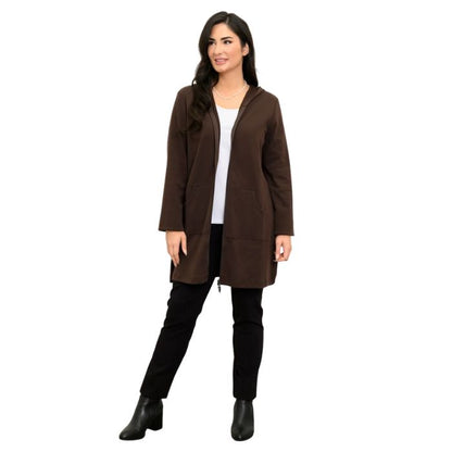 a woman wearing coffee brown cortes jacket, white jazz tank top and black nadia pants front view set on a studio white background