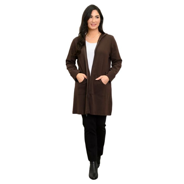 a woman wearing coffee brown cortes jacket, white jazz tank top and black nadia pants front view set on a studio white background