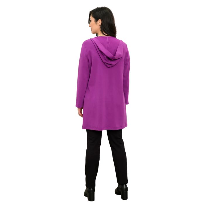 a woman wearing black cortes jacket and black nadia pants back view set on a studio white background