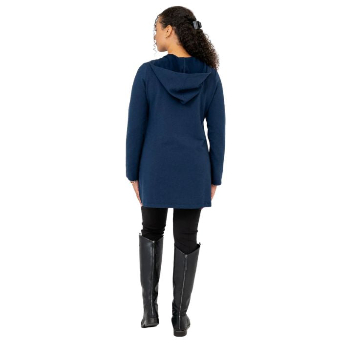 a woman wearing indigo blue cortes jacket and black dixie fleece leggings  back view set on a studio white background
