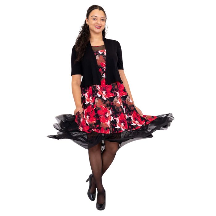 woman wearing lipstick poinsetta print danube dress and black doda jacket front view set on a white background