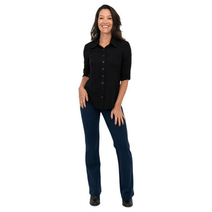 female model wearing indigo blue daya pants and black lorrine blouse front view on white background