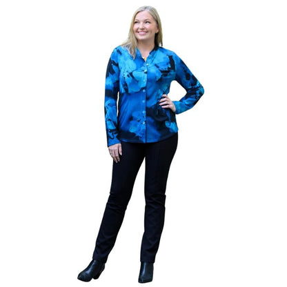 a woman wearing blue space print debbie blouse and black nadia pants front view set on a studio white background