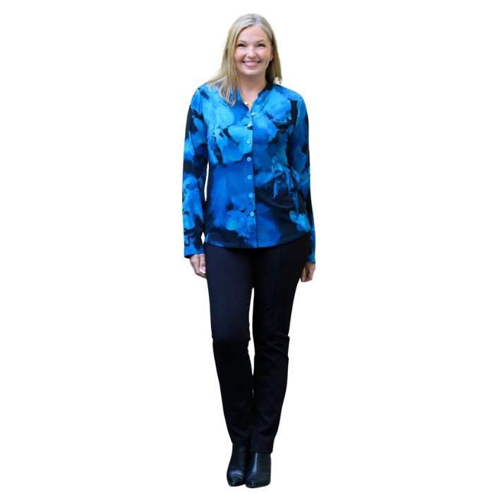 a woman wearing blue space print debbie blouse and black nadia pants front view set on a studio white background