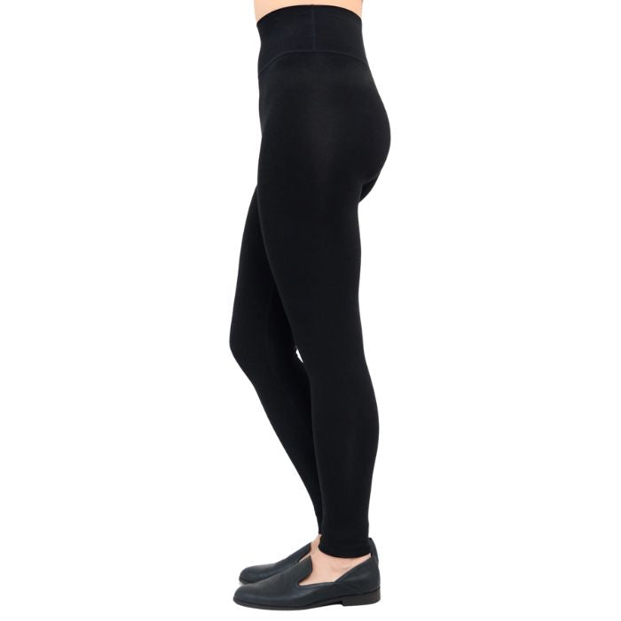 bottom of female model wearing dixie black fleece leggings side view on white background