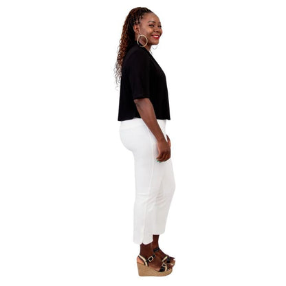 female model wearing black doda jacket, black reanna tank top and white nadine cropped pants side view on white background