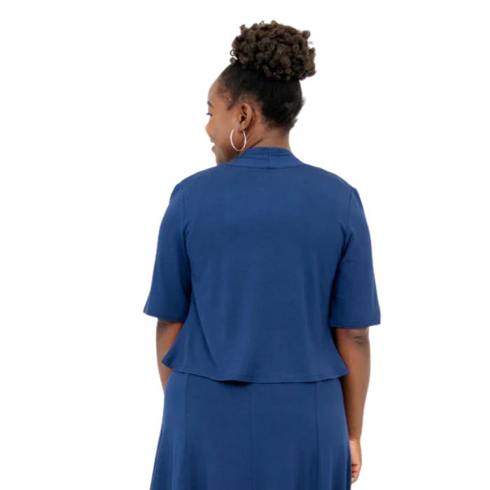 female model wearing indigo blue doda jacket back view on white background