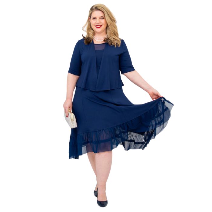 female model wearing indigo blue doda jacket and indigo blue danube dress front view on white background