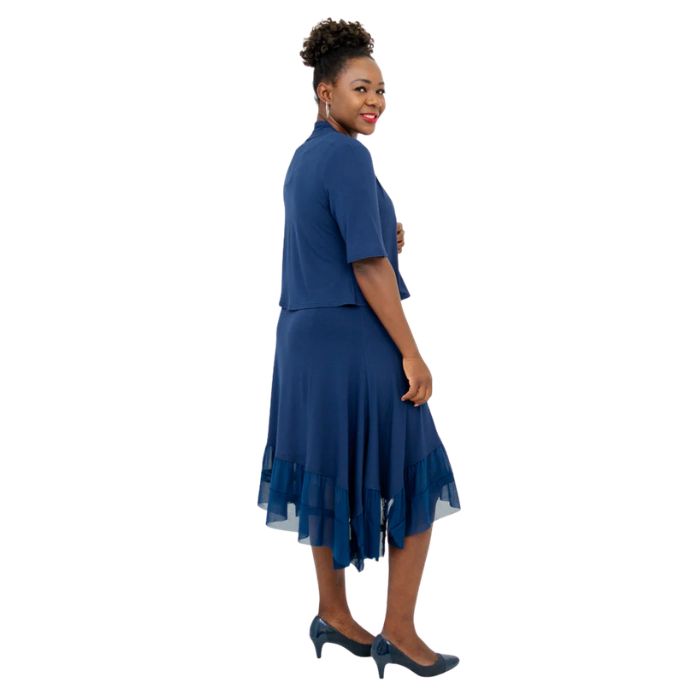 female model wearing indigo blue doda jacket and indigo blue danube dress side view on white background