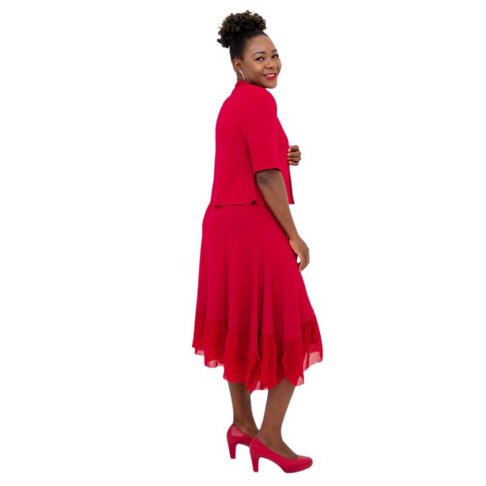 female model wearing lipstick red doda jacket and lipstick red danube dress side view on white background