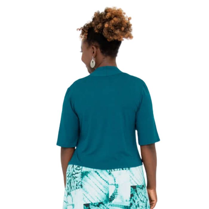 female model wearing teal green doda jacket back view on white background