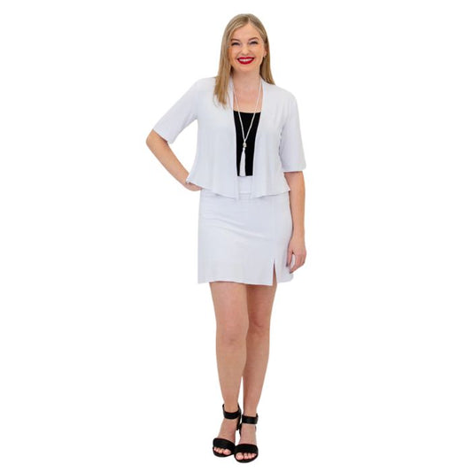 female model wearing white doda jacket, black avalon tank top and white melly skort front view on white background