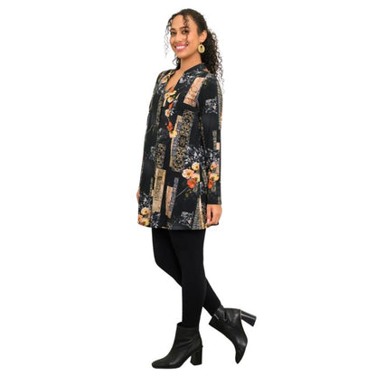 a woman wearing golden garden print edwina tunic top and black dixie legging pants side view set on a studio white background
