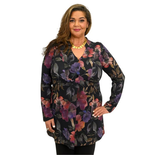 a woman wearing pink petal print edwina tunic waist up front view set on a studio white background