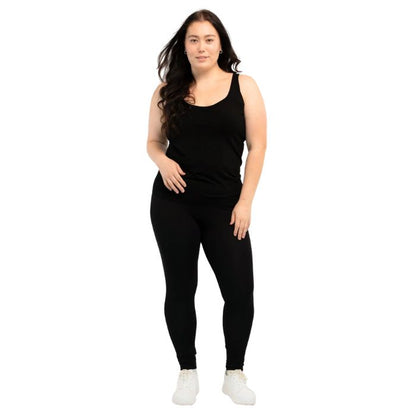 female model wearing black effortless bra in tank top and black suri leggings front view on white background