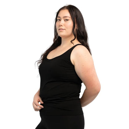 female model wearing black effortless bra in tank top side view on white background