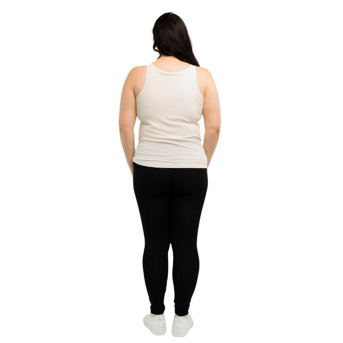 female model wearing cream white effortless bra in tank top and black suri leggings back view on white background