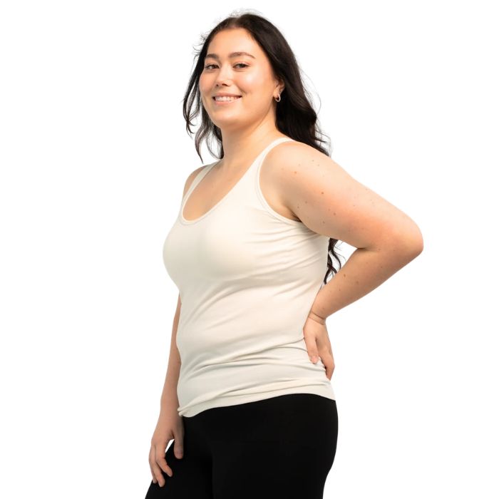 female model wearing cream white effortless bra in tank top side view on white background