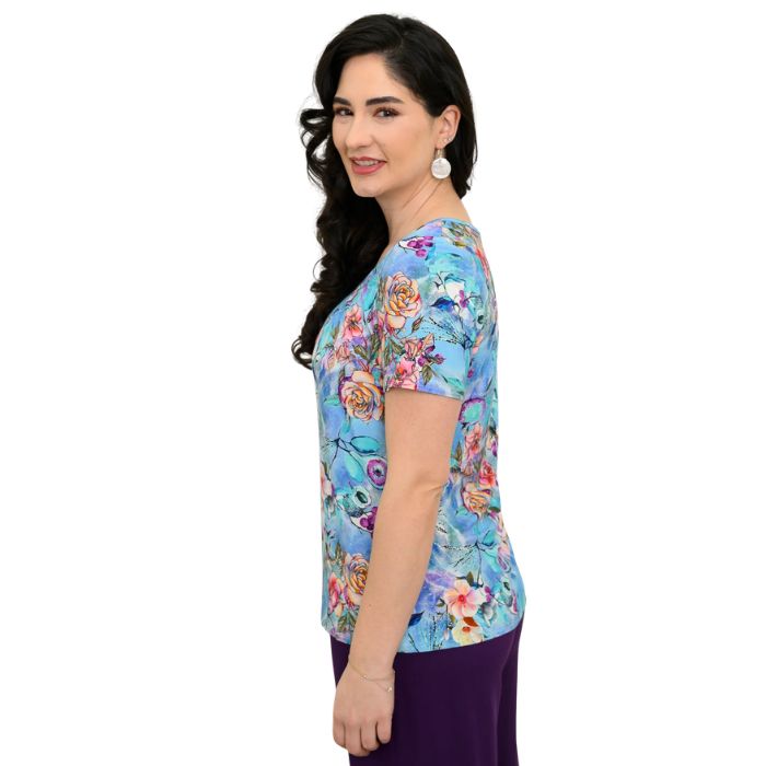 female model wearing teal nectar print emery top side view on white background