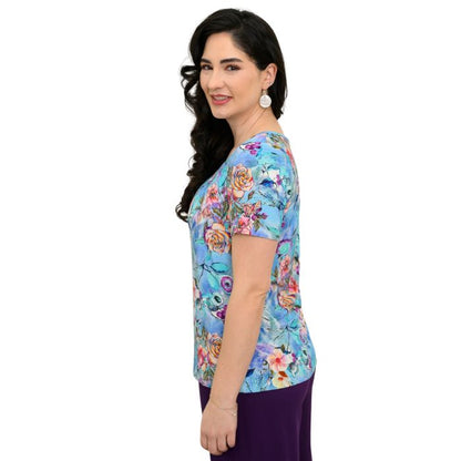 female model wearing teal nectar print emery top side view on white background