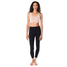female mode wearing beige brown essential bralette and black suri leggings front view on white background