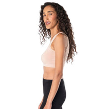 top of female model wearing beige brown essential bralette side view on white background