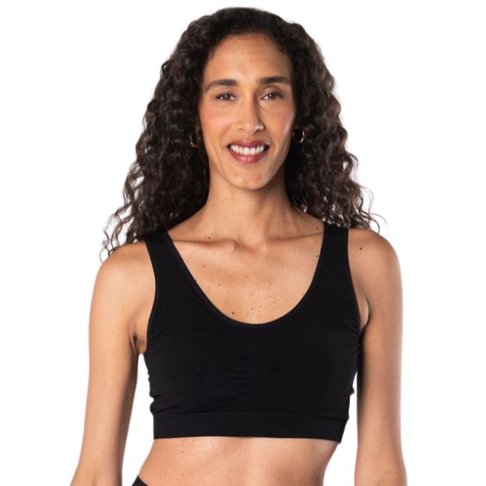 female model wearing black essential bralette front view on white background