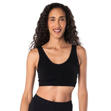 top of female model wearing black  essential bralette front view on white background