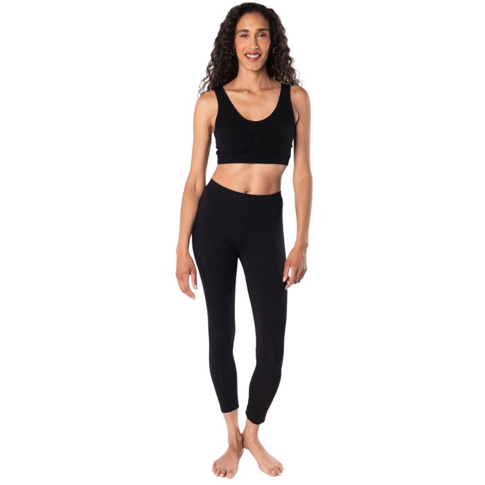 female mode wearing black essential bralette and black suri leggings front view on white background