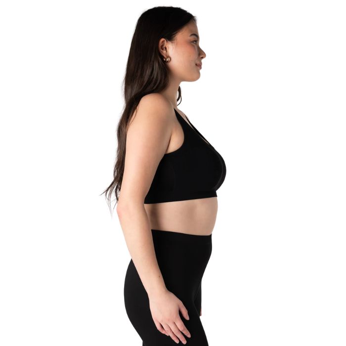 emale model wearing black essential bralette side view on white background