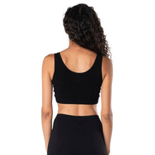 top of female model wearing black  essential bralette back view on white background