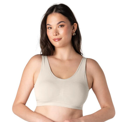 female model wearing cream white essential bralette front view on white background